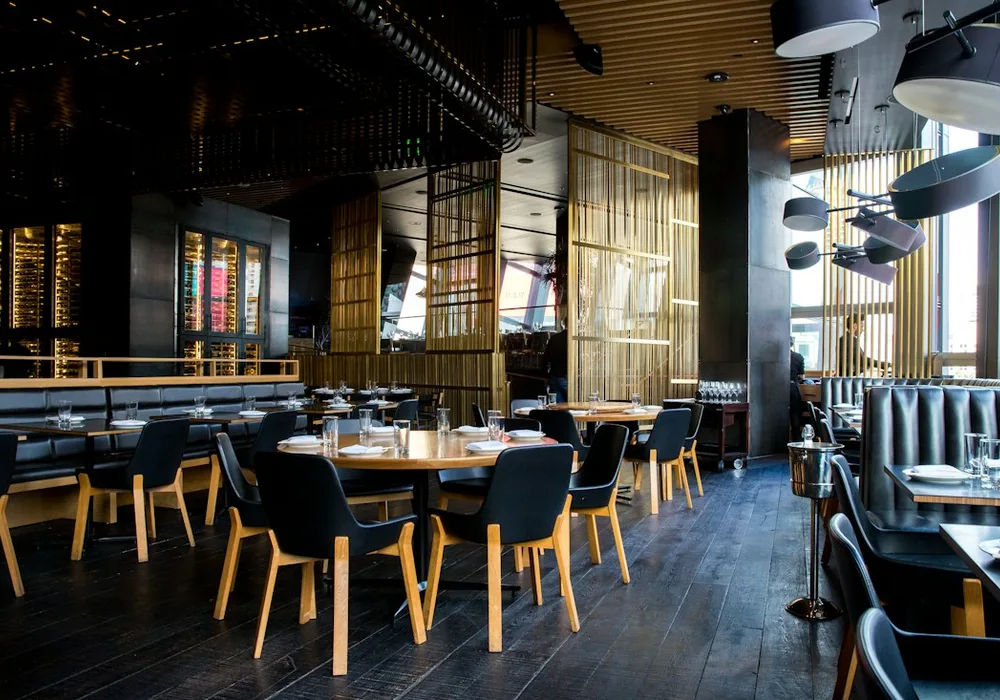 Warm restaurant interior with tables set for guests